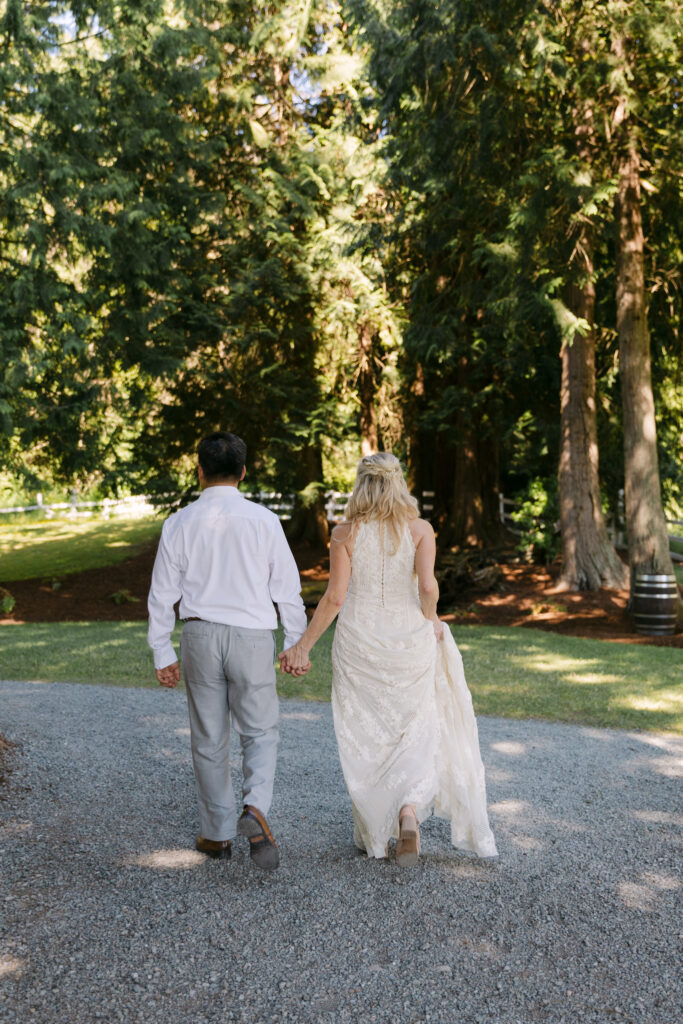 Bride and groom walking toward the trees during portraits at Chateau Lill.