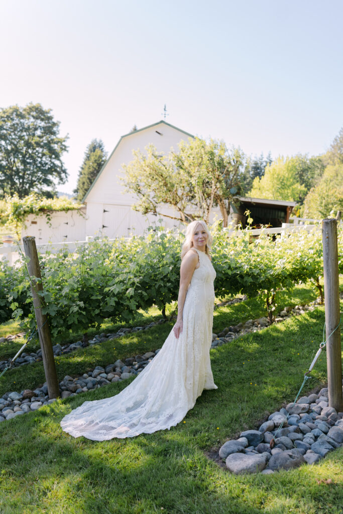 Bride standing in front of vineyard greenery during Chateau Lill wedding portraits.