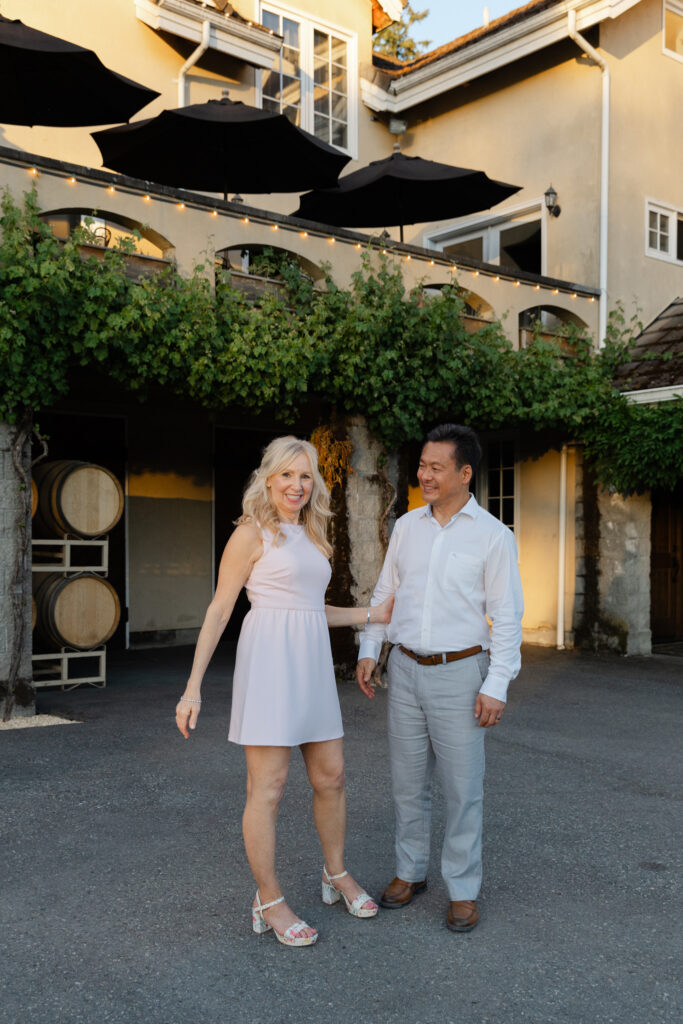 Bride and groom standing outside Chateau Lill during golden hour portraits.