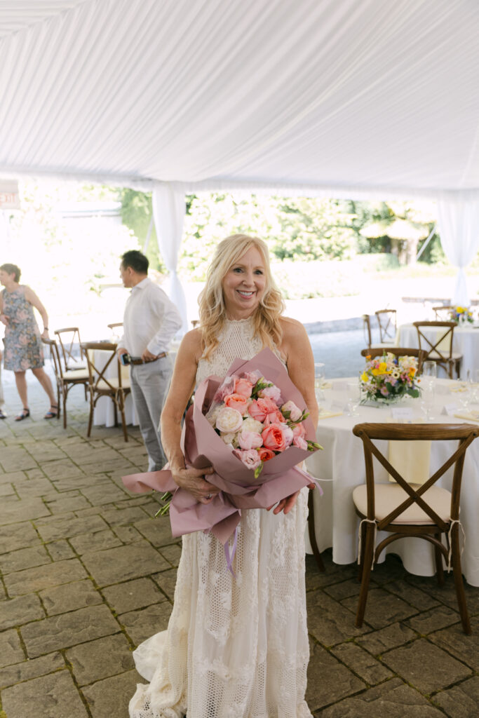 Bride holding a bouquet of roses.