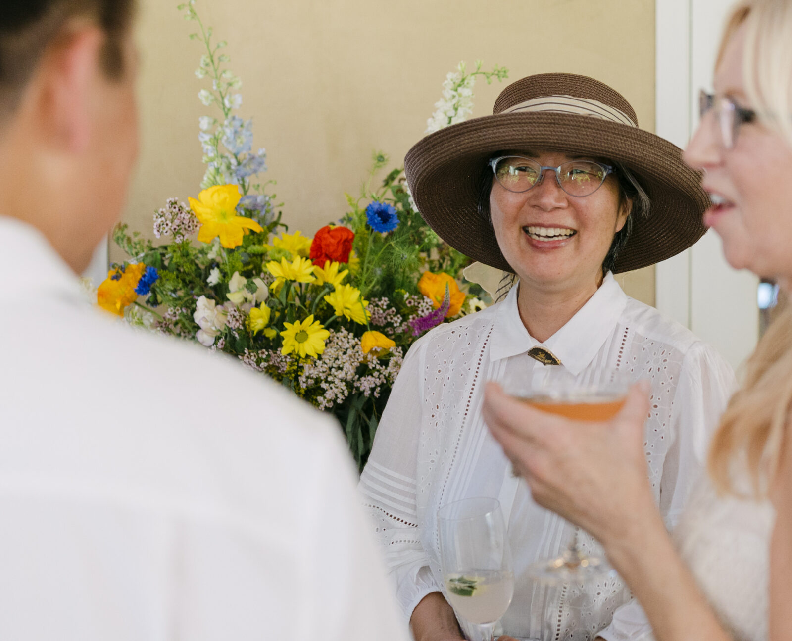 Wedding guest smiling during cocktail hour on The Terrace Patio at Chateau Lill.