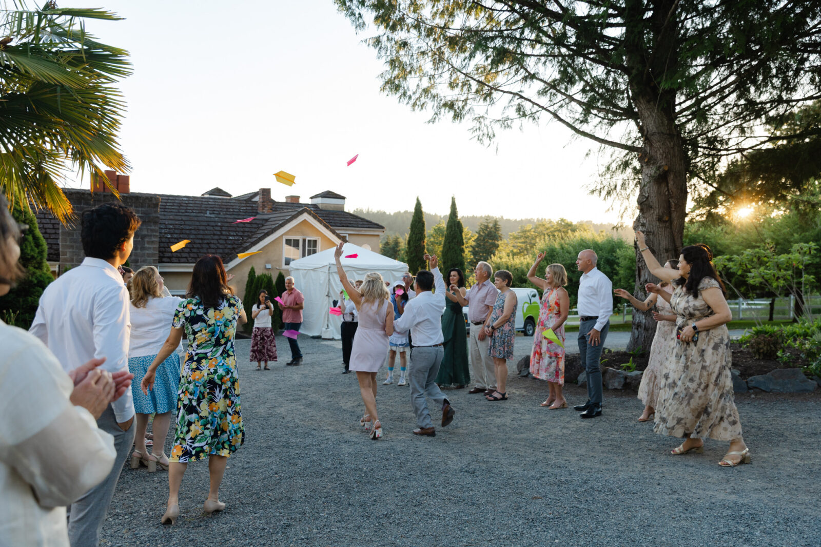 Bride and groom running through paper airplanes during their Chateau Lill wedding reception.