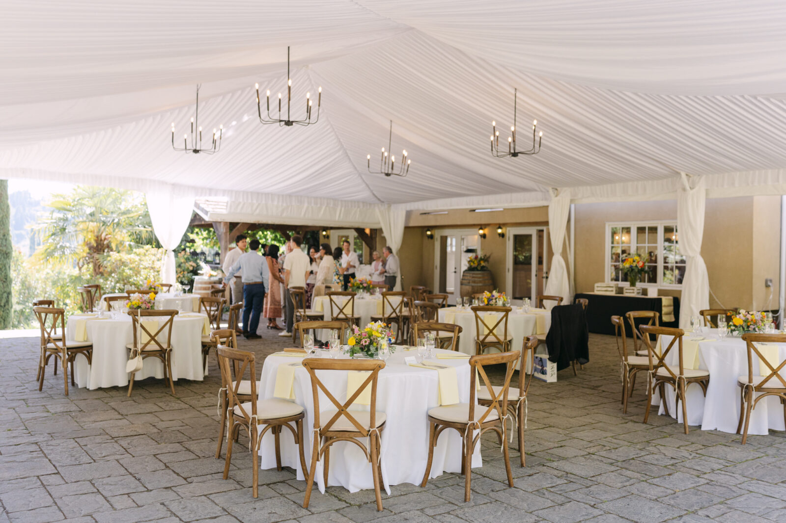 Reception tables set under the tent on The Terrace Patio at Chateau Lill.