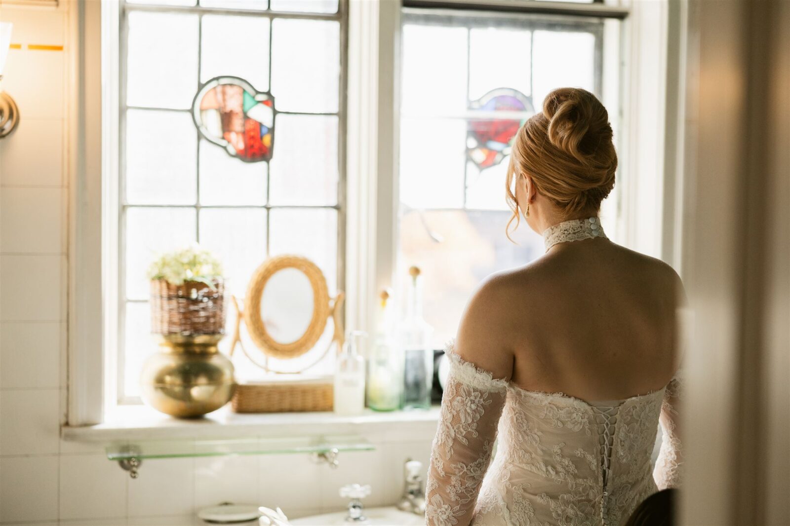 Bride getting ready in the bathroom of a suite at Thornewood Castle.
