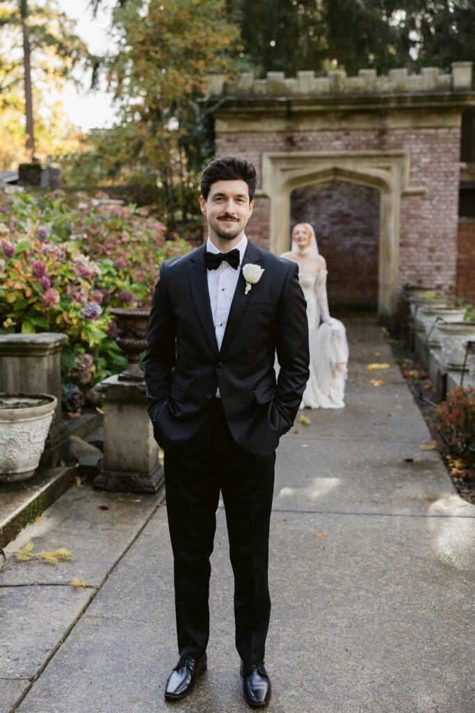 Bride approaching the groom during their first look in the Sunken Gardens at Thornewood Castle in Lakewood, Washington.