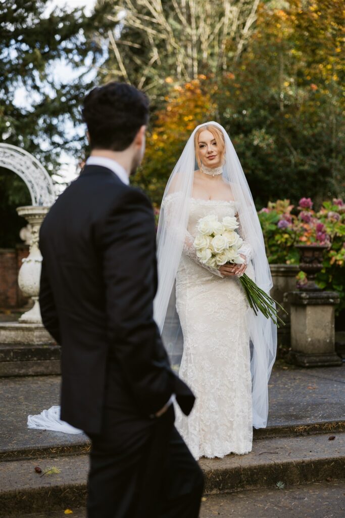 Editorial style portrait of the bride and groom posing in the sunken secret garden.