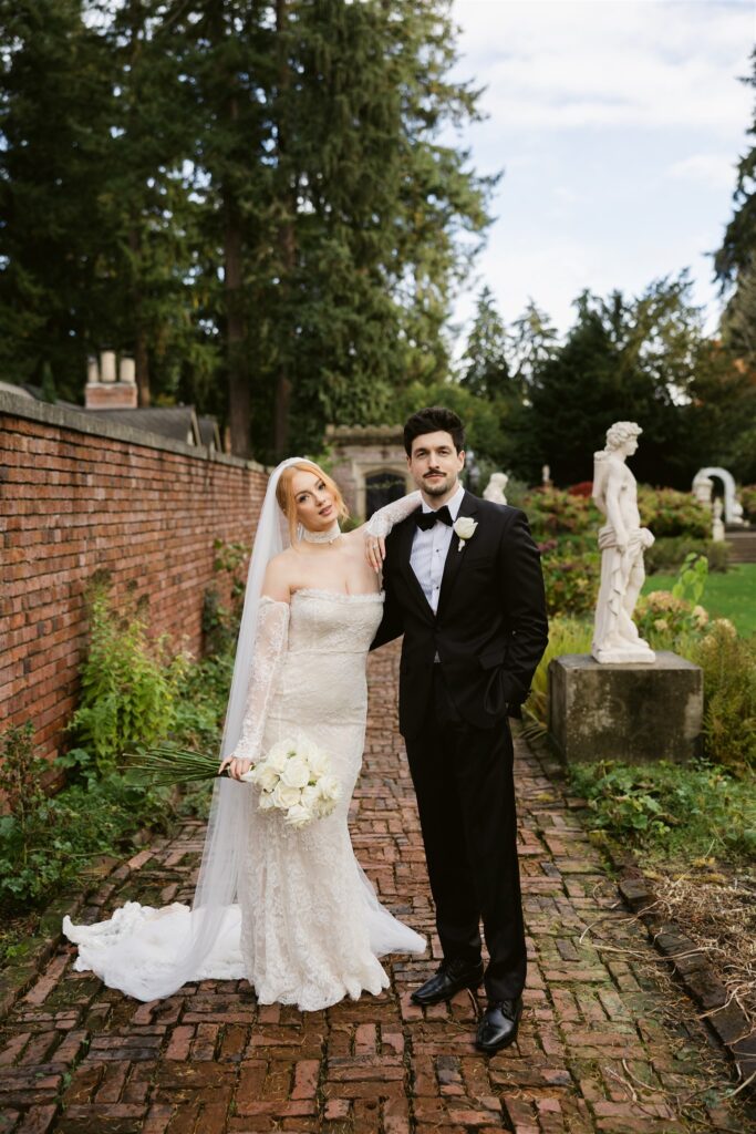Bride and groom posing in the Sunken Garden at Thornewood Castle in Lakewood, WA.