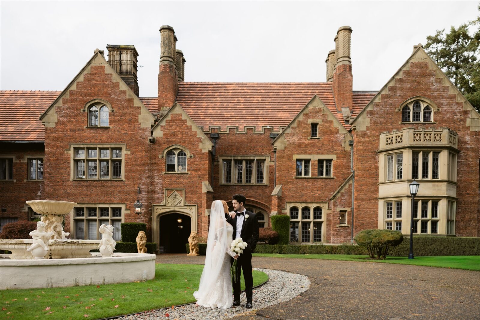 Bride and groom posing outside of Thornewood Castle in Lakewood, Washington.