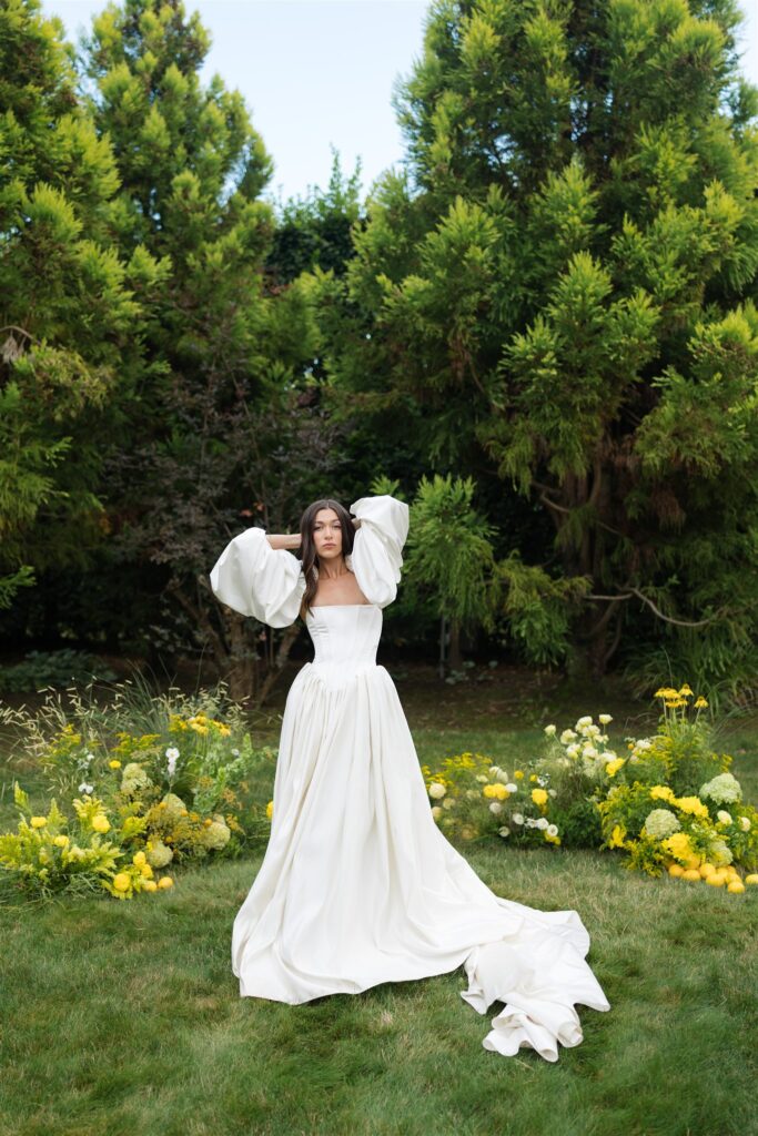 Bride standing in garden ceremony space at Briarwood Estate wedding with yellow florals and greenery.