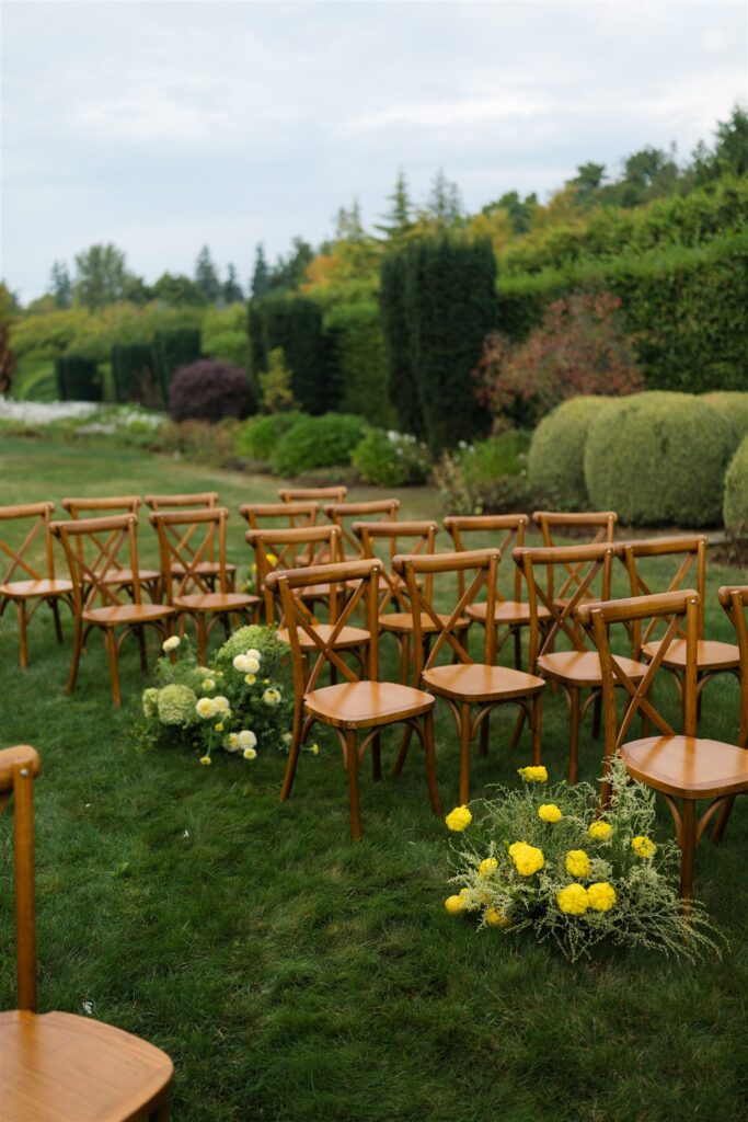 Ceremony setup with wooden chairs and yellow floral arrangements at Briarwood Estate wedding venue in Washington.
