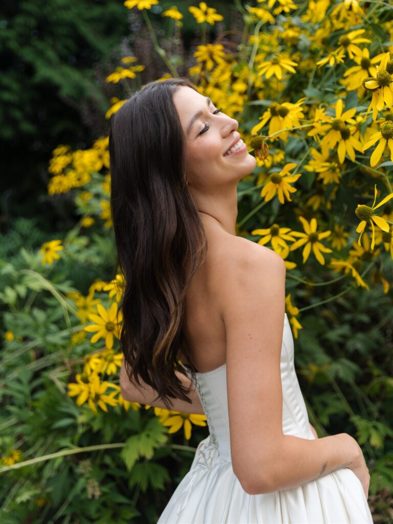 Bride smiling in yellow floral garden at Briarwood Estate wedding venue in Washington.