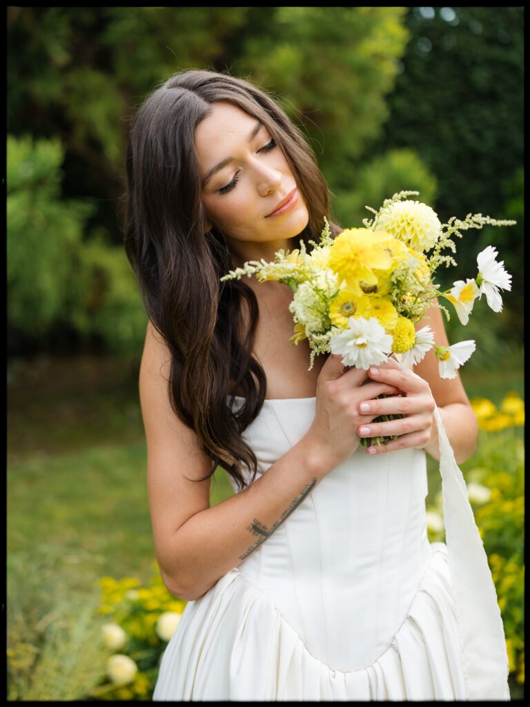 Bride portrait with yellow and white bouquet in garden setting at Briarwood Estate wedding.