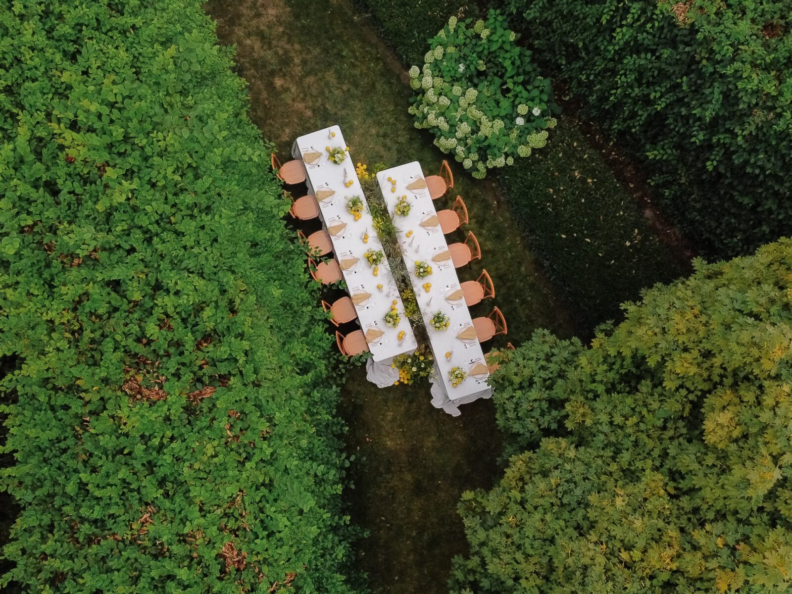 Aerial view of long reception tables styled with yellow florals and greenery at Briarwood Estate wedding in Washington.