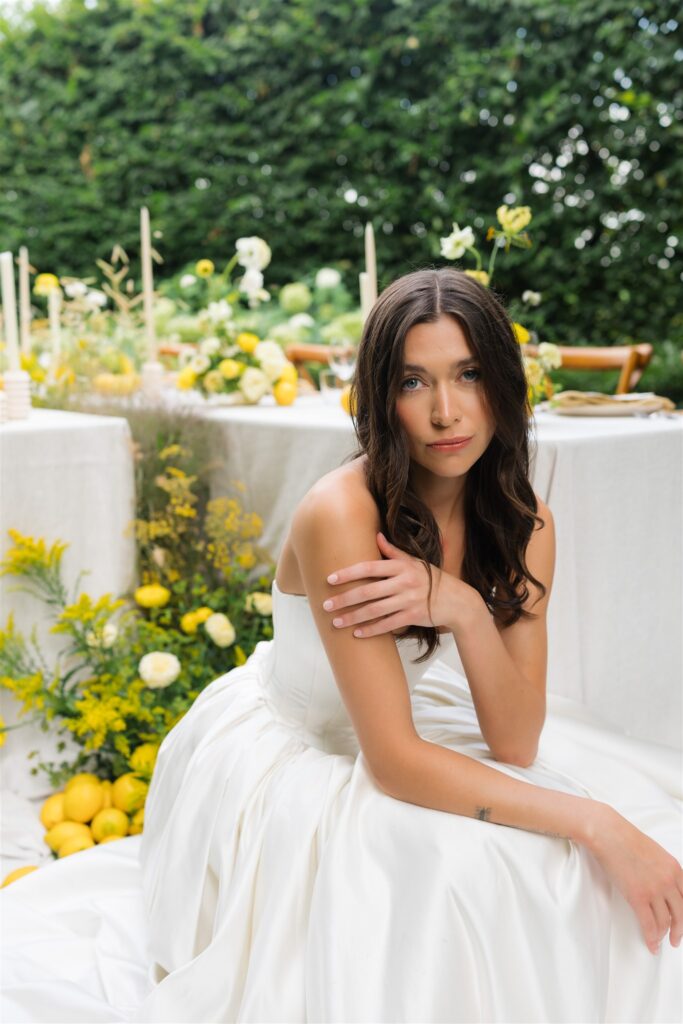 Close up portrait of a bride sitting in front of a wedding reception table at Briarwood Estate in WA. 