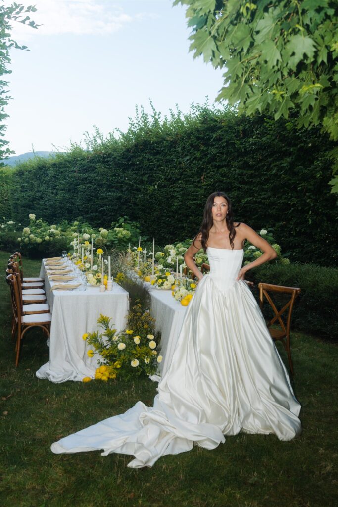 Direct flash portrait of a bride standing in front of a styled wedding reception table at Briarwood Estate in WA. 