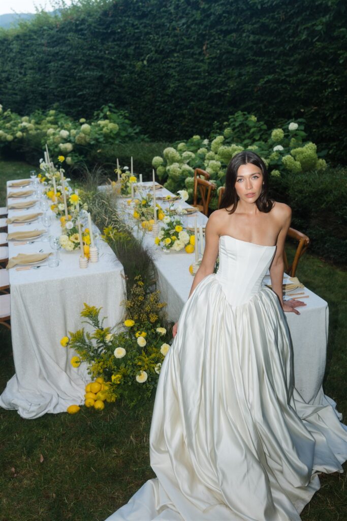 Direct flash portrait of a bride sitting in front of a styled wedding reception table at Briarwood Estate in WA. 