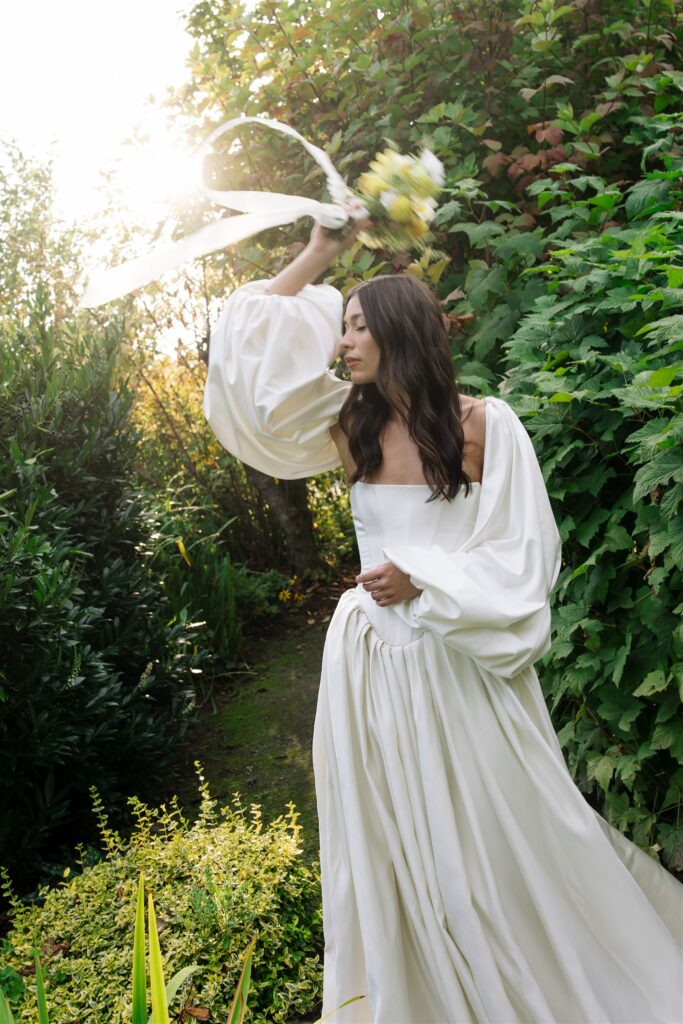 Whimsical wedding portrait of a bride in the gardens of Briarwood Estate in Washington. 