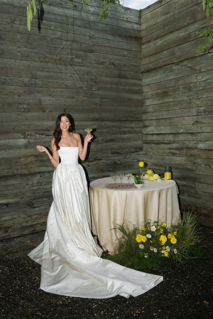Flash portrait of a bride posing with a cocktail in hand. 