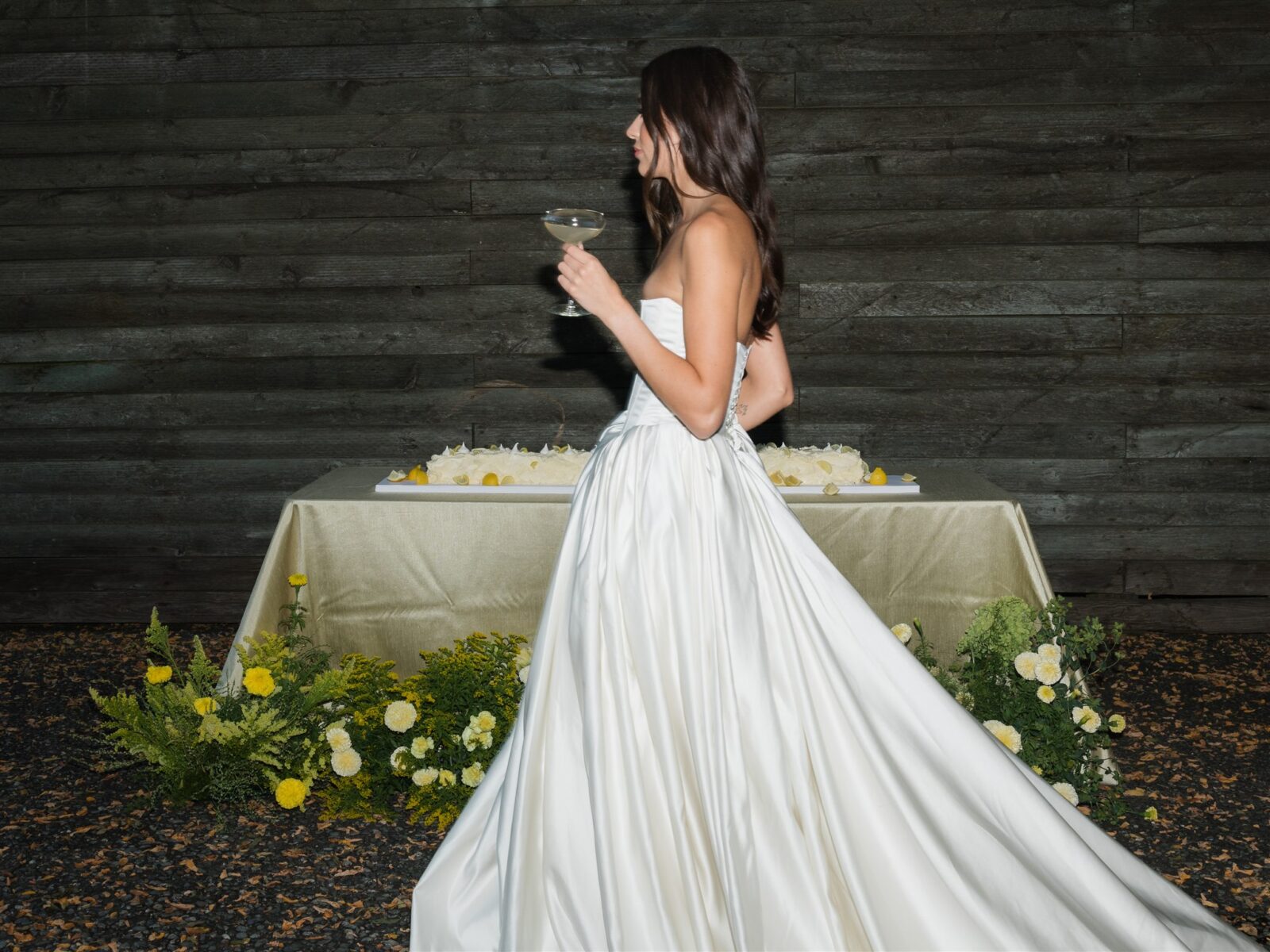 Bride walking with a cocktail in hand during the reception.