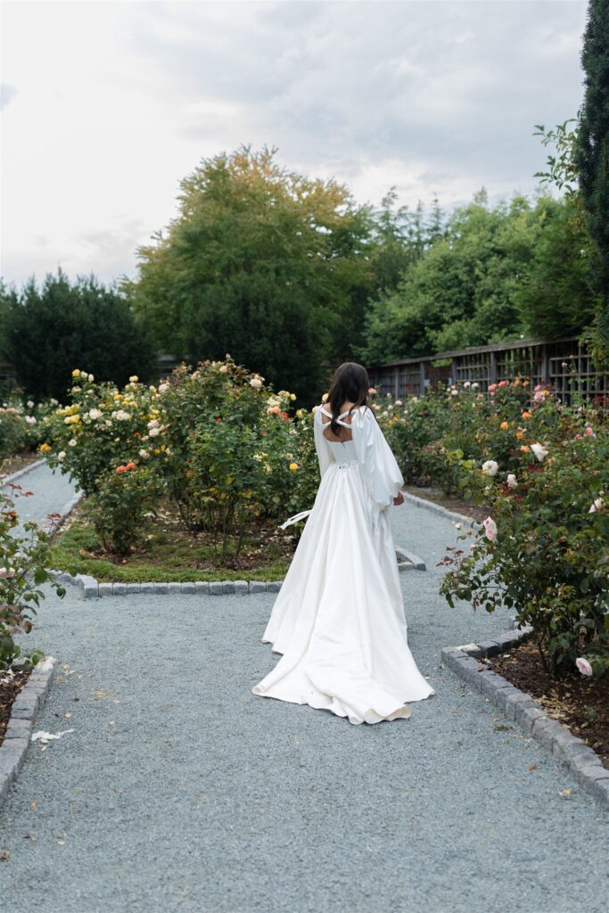 Bride walking through rose garden pathways at Briarwood Estate wedding venue in Washington.