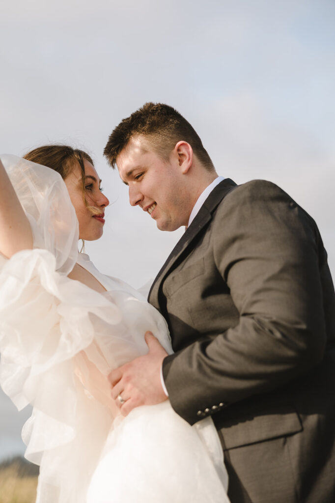 Bride and groom posing close together.