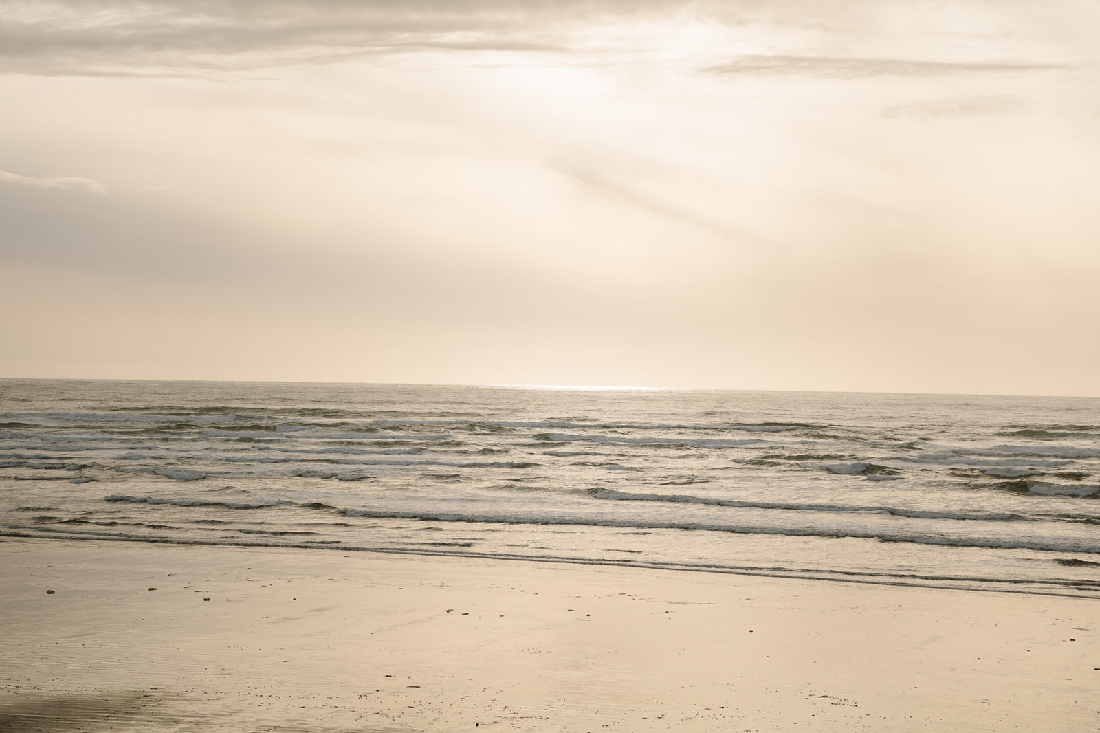 Wide landscape shot of the ocean on Cannon Beach during golden hour.