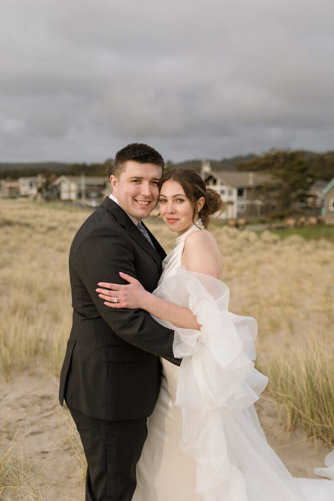 Couple smiling for a portrait during their Cannon Beach elopement.