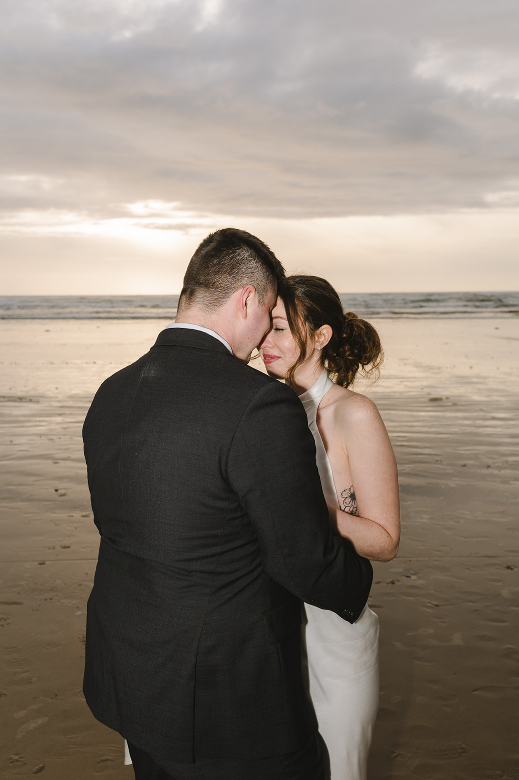 Direct flash photo of a bride and groom standing face to face during their Cannon Beach elopement.