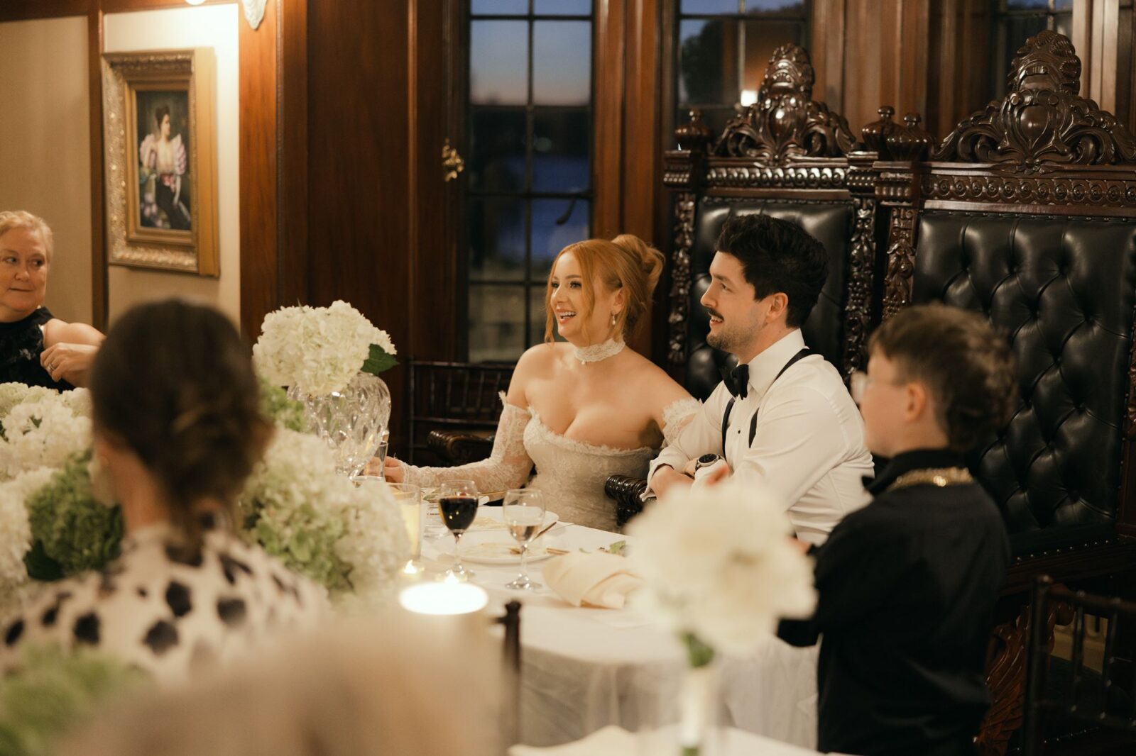 Bride and groom having dinner during their ballroom reception at Thornewood Castle in WA.