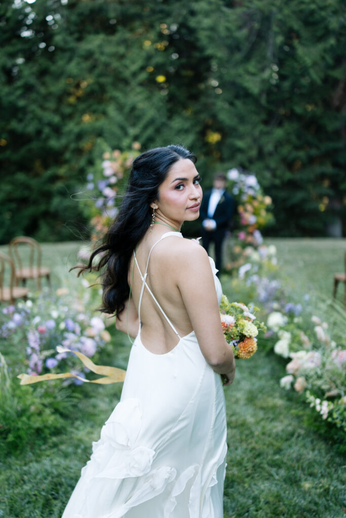 Bride portrait with colorful ceremony flowers on the Amphitheater Lawn at Foxglove Lodge Vashon Island.