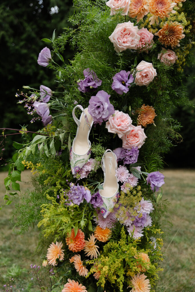 Floral wedding shoes styled in colorful flowers for Foxglove Lodge Vashon Island wedding inspiration.