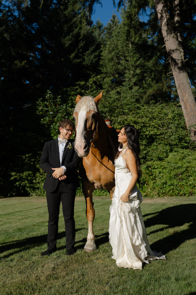 Couple posing with a horse during wedding portraits at Foxglove Lodge Vashon Island.
