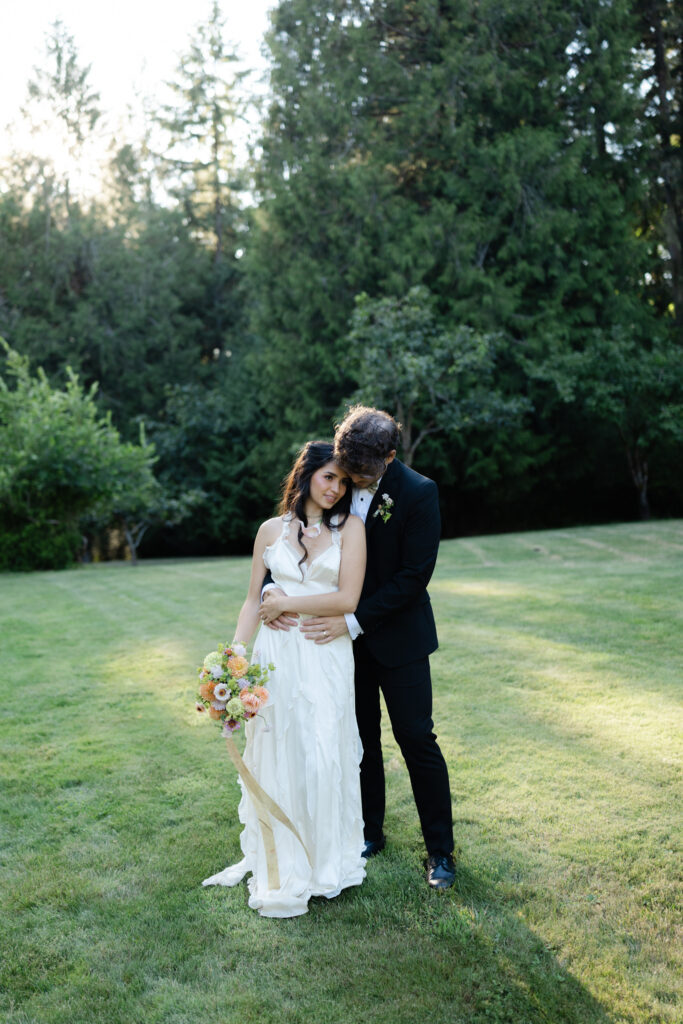 Couple poses together during golden hour portraits at Foxglove Lodge Vashon Island.