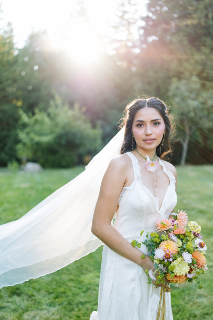Bride portrait with colorful bouquet and veil during golden hour at Foxglove Lodge Vashon Island.