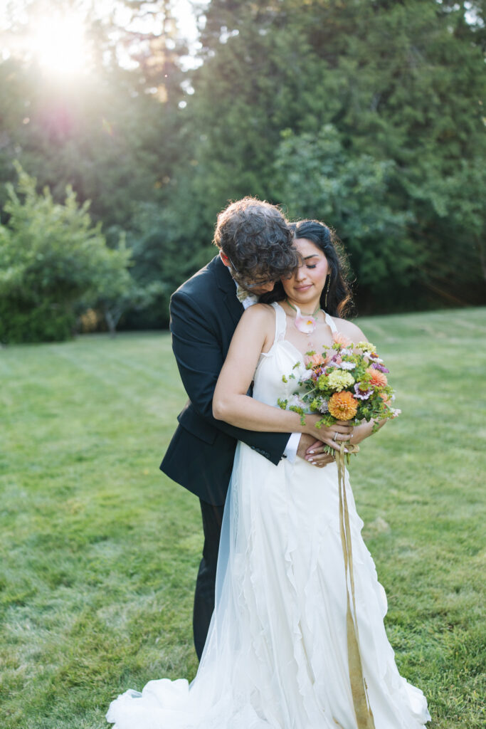 Couple embracing during golden hour wedding portraits at Foxglove Lodge Vashon Island.