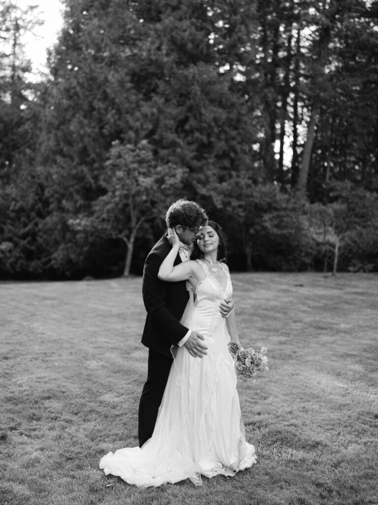 Black and white photo of a couple embracing outdoors.