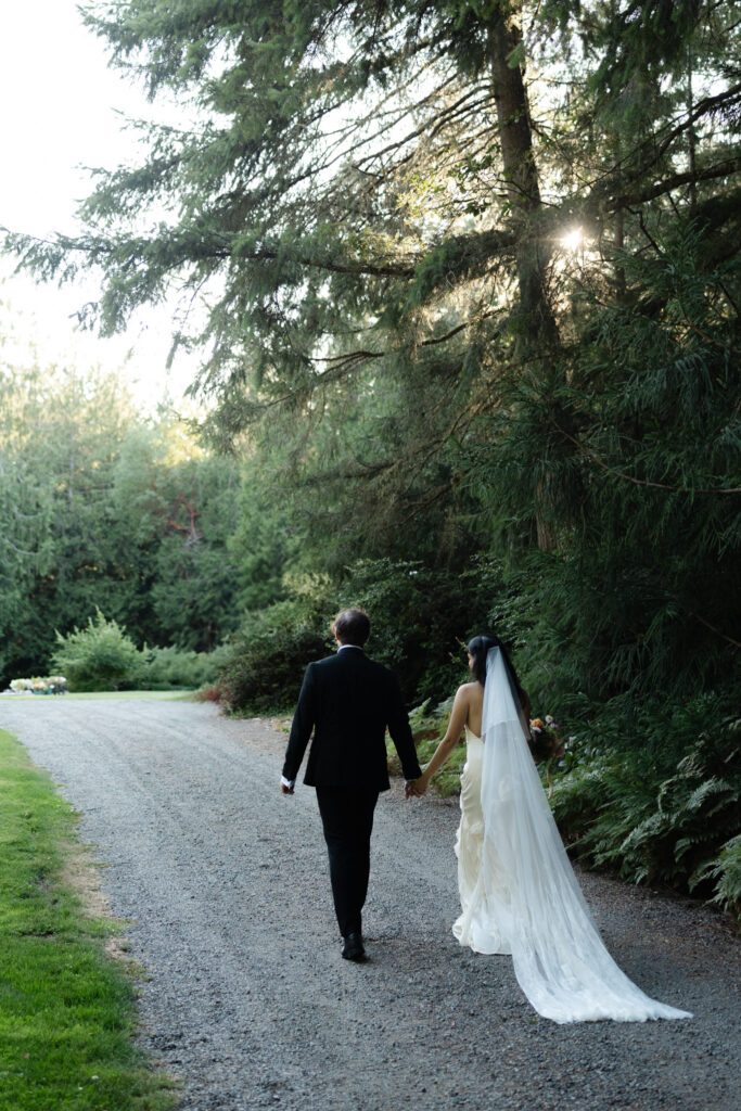 Couple walking down a dirt pathway at Foxglove Lodge in Vashon, Island.
