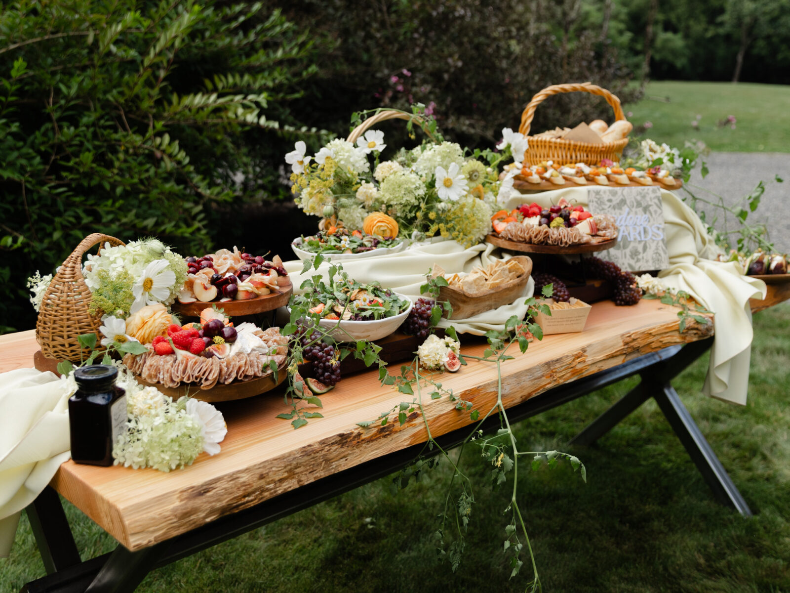 Grazing table with fruit, flowers, and bread for a wedding reception at Foxglove Lodge Vashon.