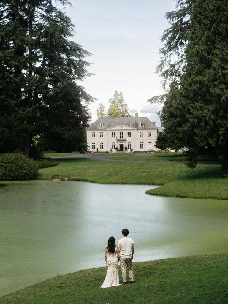Couple admiring The Residence at Bloedel Reserve for their romantic Washington engagement photos.