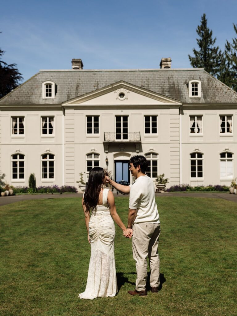 Man caressing his fiancés face during their Bloedel engagement photos in front of The Residence.