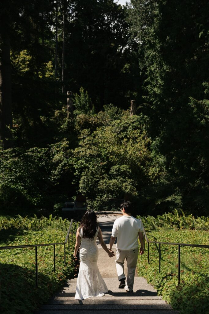 Couple walking down a stairway outdoors.