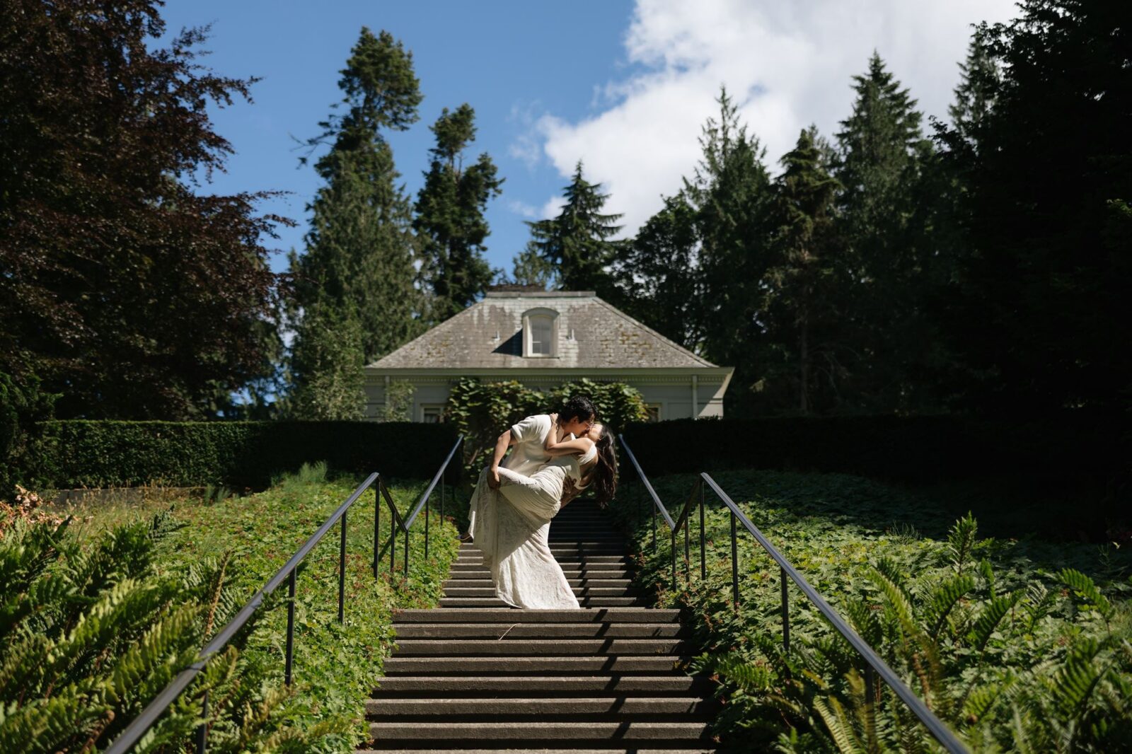 Couple kissing on top of a staircase for their outdoor Washington engagement photos.