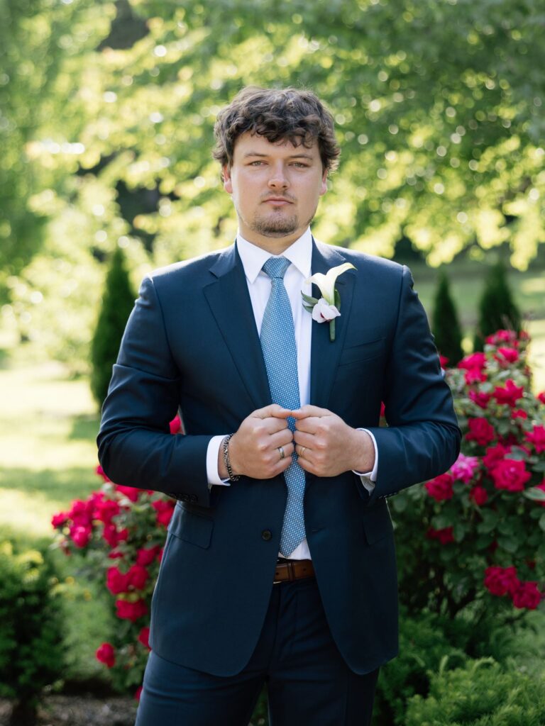 Groom posing in the gardens.