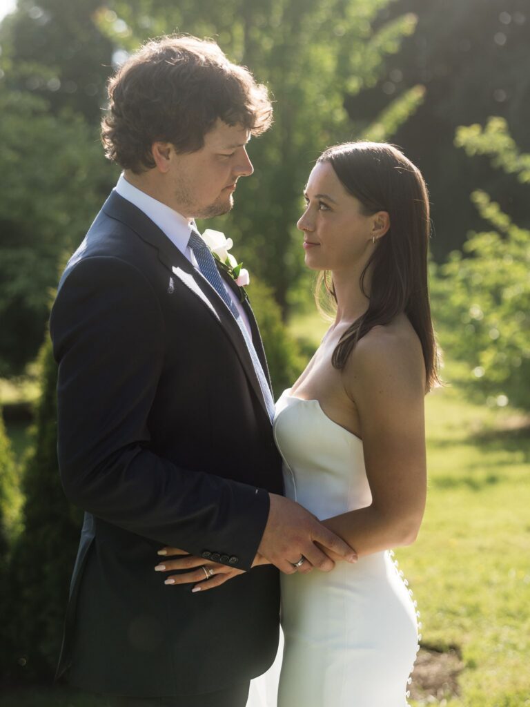 Bride and groom posing in the gardens during golden hour.