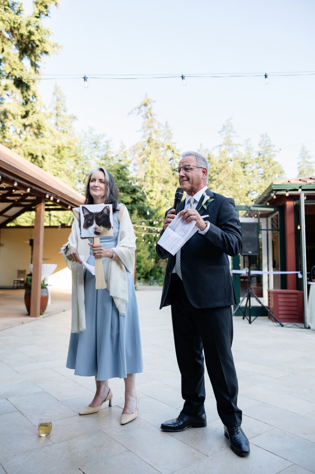 Guests giving a speech during a Froggsong Gardens wedding reception.