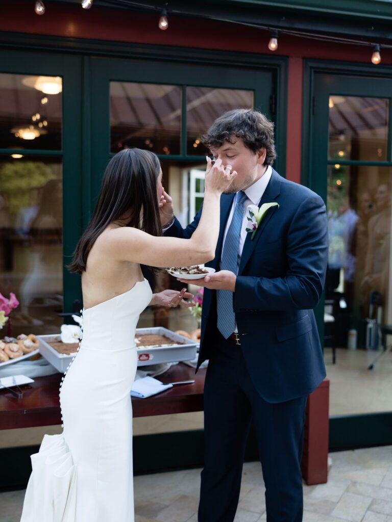 Bride and groom feeding each other cake.