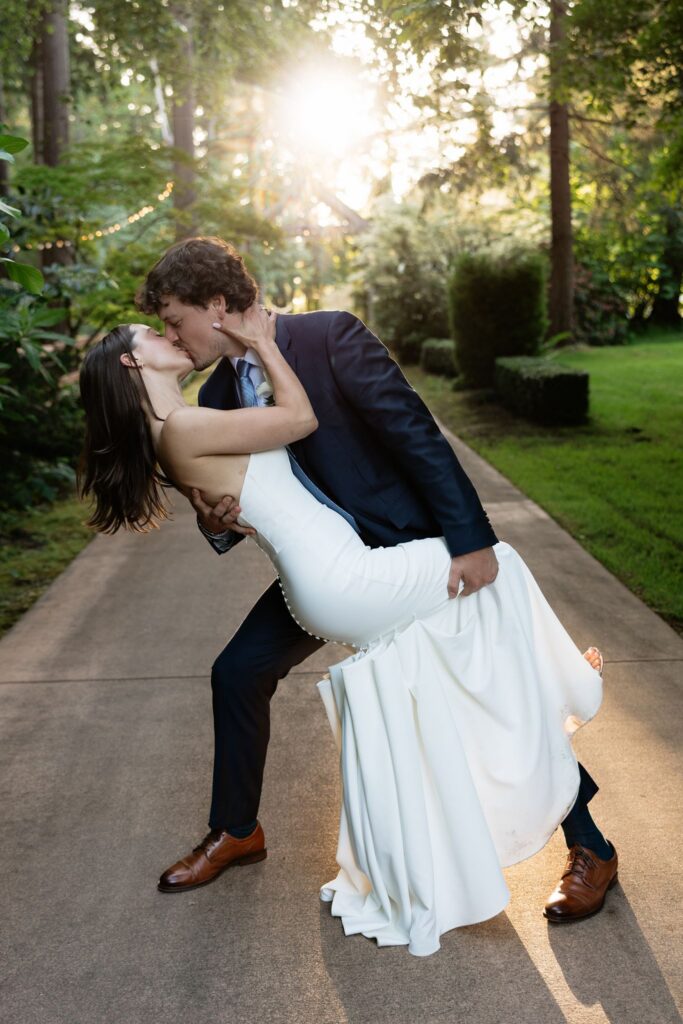 Bride and groom kissing during golden hour for their Froggsong Gardens wedding portraits.