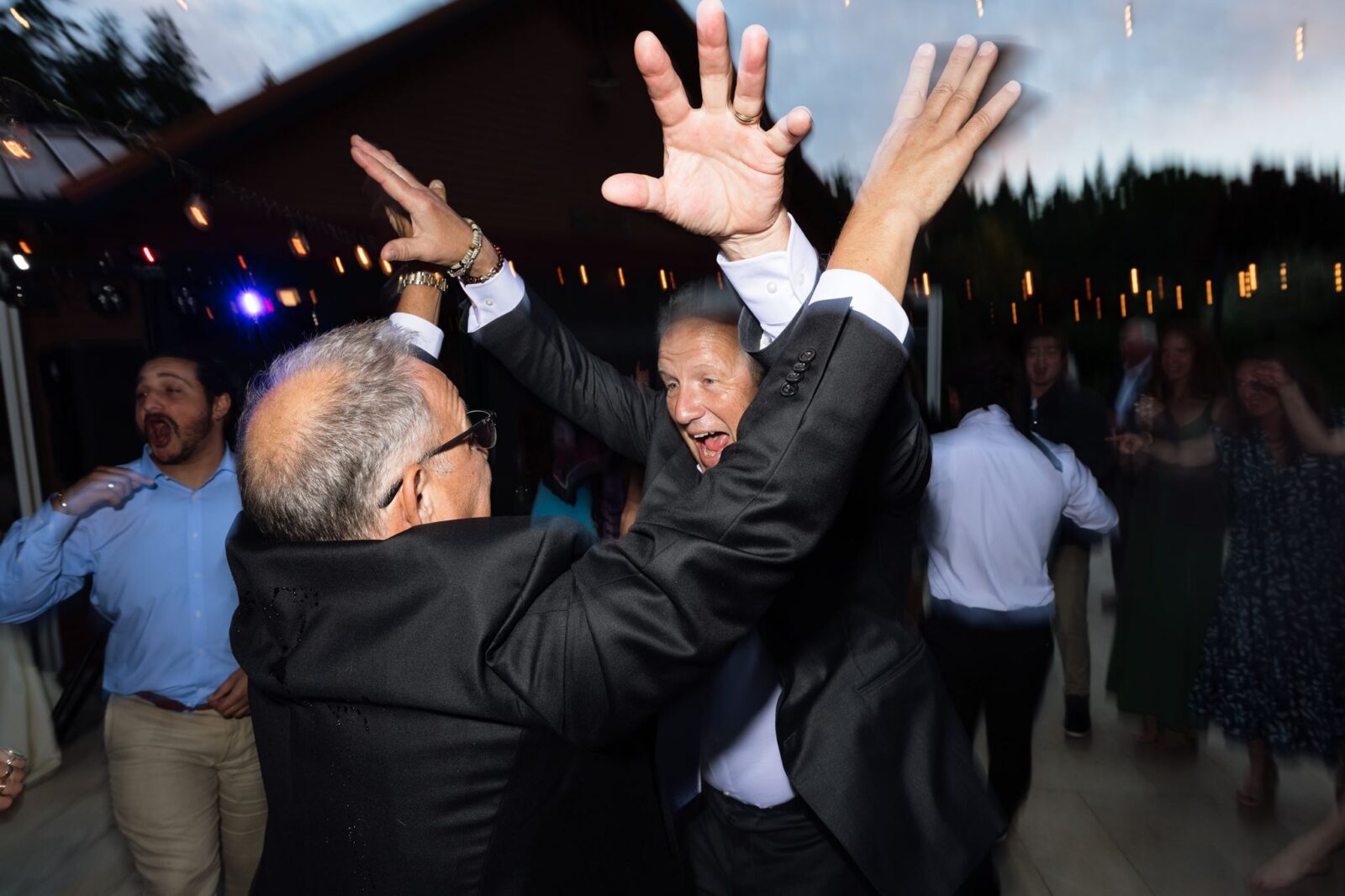 Guests dancing under twinkle lights.