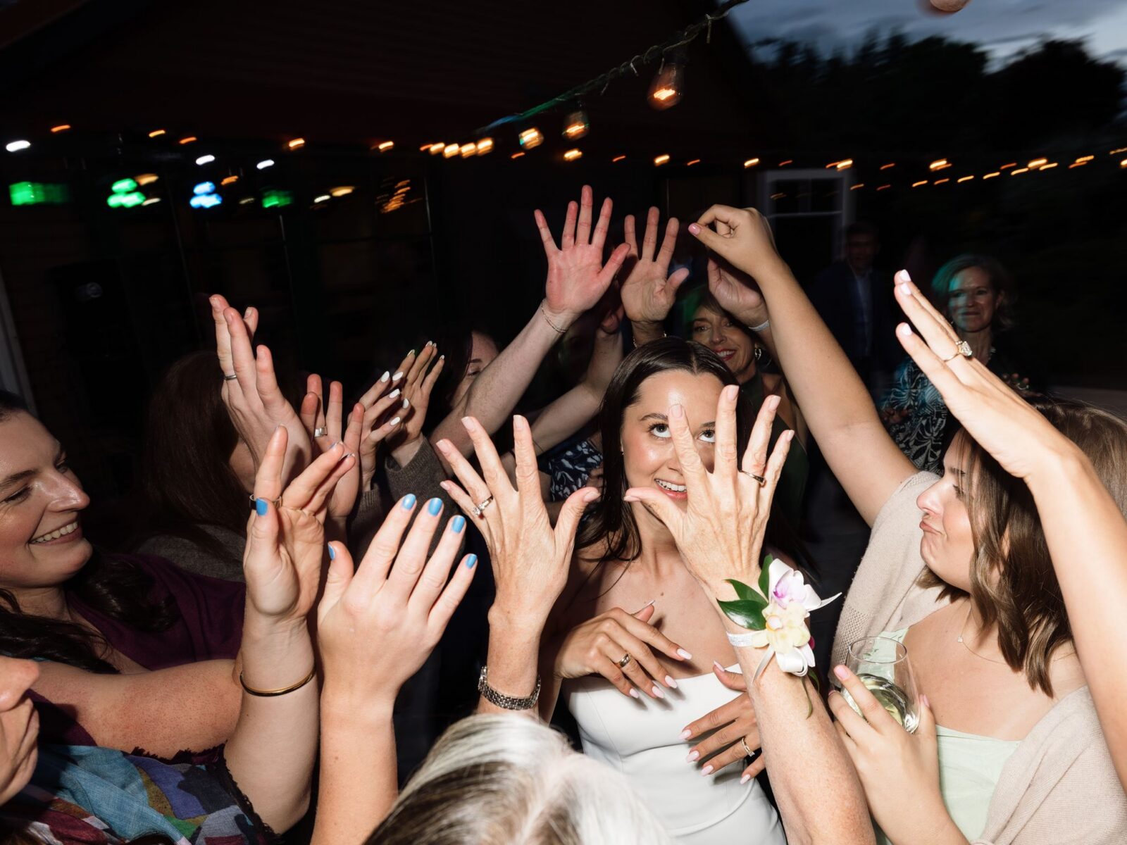 Bride dancing as everyone has their hands in the air.