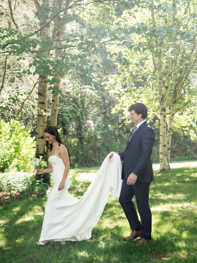Bride and groom walking together outside at Froggsong Gardens in Vashon Island, WA.